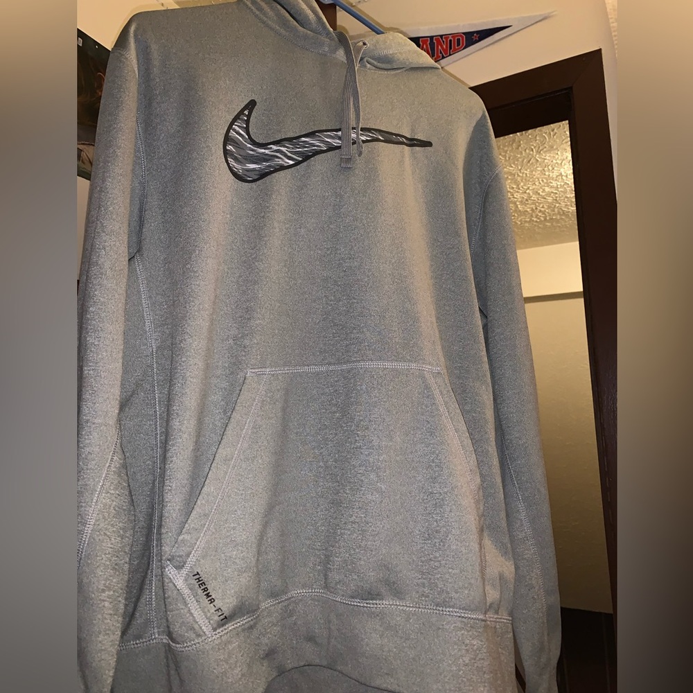A large, Therma-fit, grey nike hoodie.